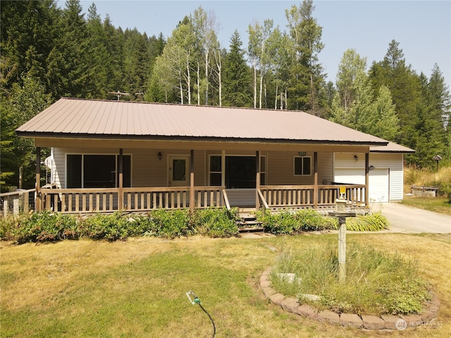 view of front facade featuring a garage, covered porch, and a front lawn