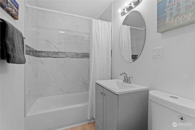 full bathroom with hardwood / wood-style flooring, vanity, shower / tub combo with curtain, and toilet