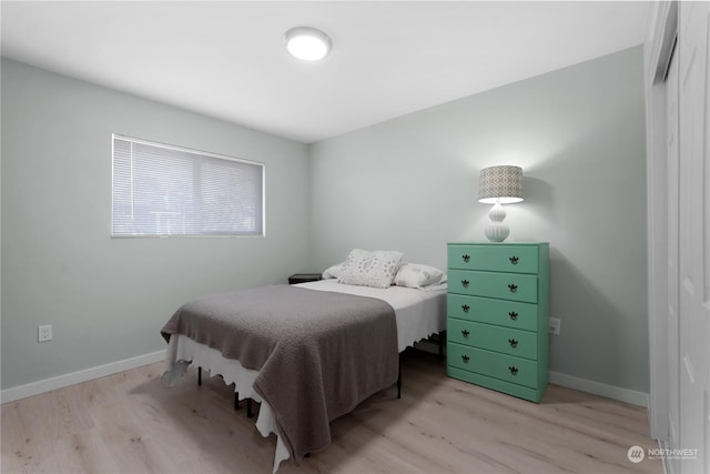 bedroom with a closet and light hardwood / wood-style flooring