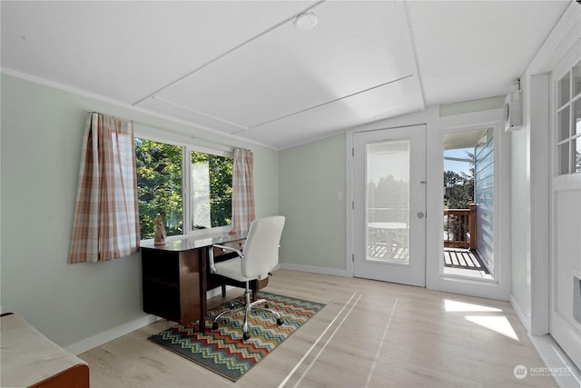 office area with french doors, vaulted ceiling, light hardwood / wood-style flooring, and a wealth of natural light