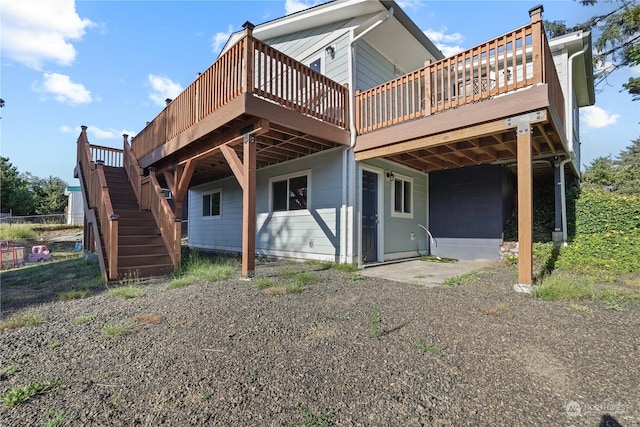 back of house featuring a wooden deck