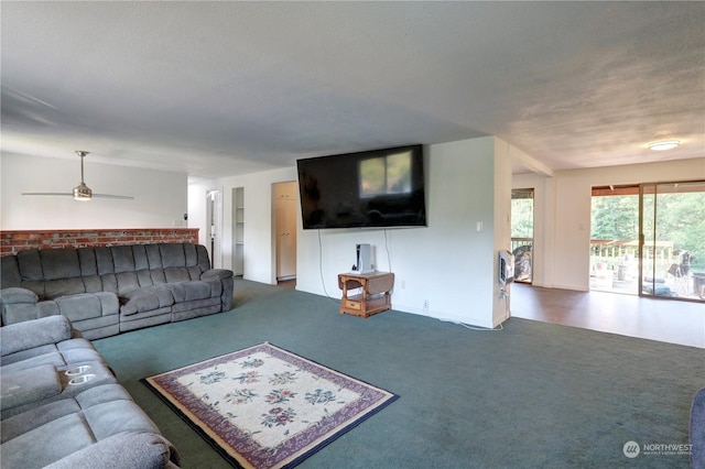 living room featuring ceiling fan and carpet