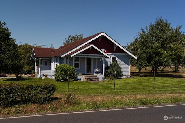 view of front of house featuring a front lawn and covered porch