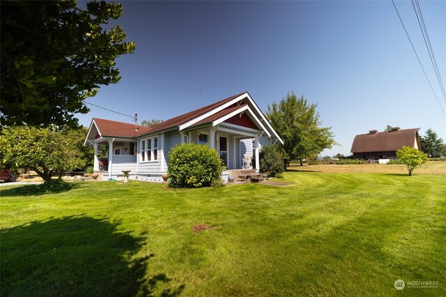 view of side of property with a lawn