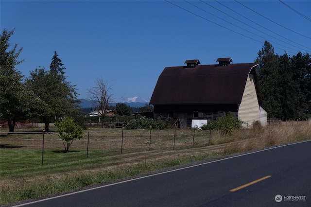 view of side of home featuring an outbuilding