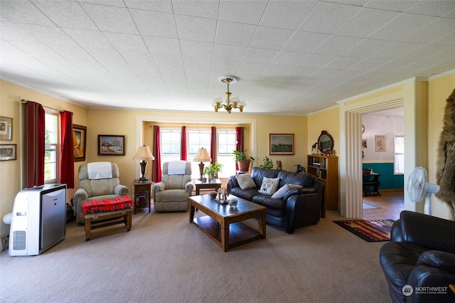 living room featuring an inviting chandelier, crown molding, plenty of natural light, and carpet flooring