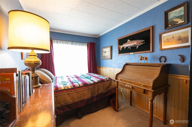 carpeted bedroom with wooden walls and ornamental molding