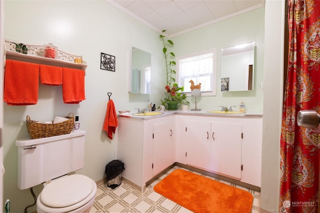 bathroom with ornamental molding, toilet, and vanity