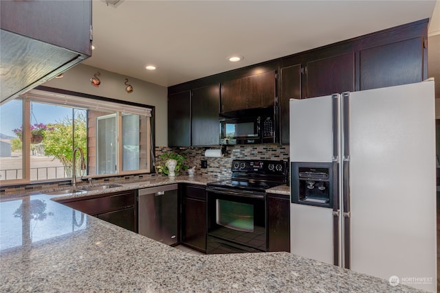 kitchen featuring light stone counters, black appliances, dark brown cabinetry, backsplash, and sink