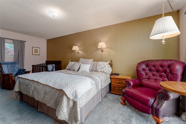 bedroom with a textured ceiling and carpet