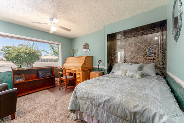 bedroom with ceiling fan, a textured ceiling, and light carpet