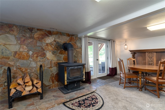 dining room featuring a wood stove and french doors