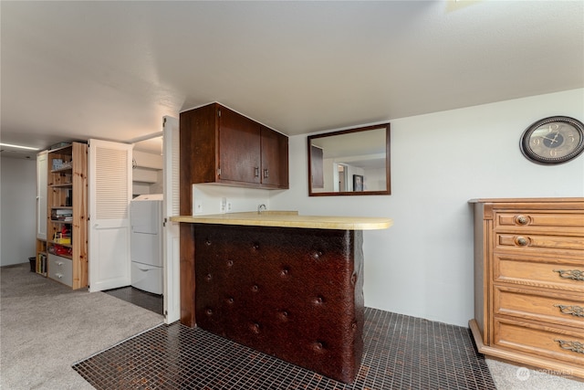 kitchen featuring dark brown cabinets, white fridge, light carpet, and kitchen peninsula