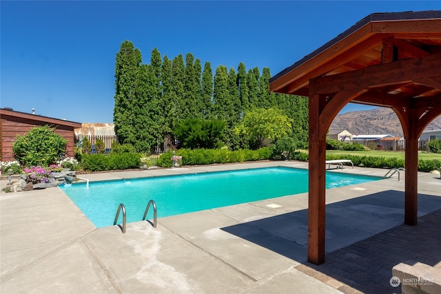 view of pool featuring a patio, a diving board, and a gazebo