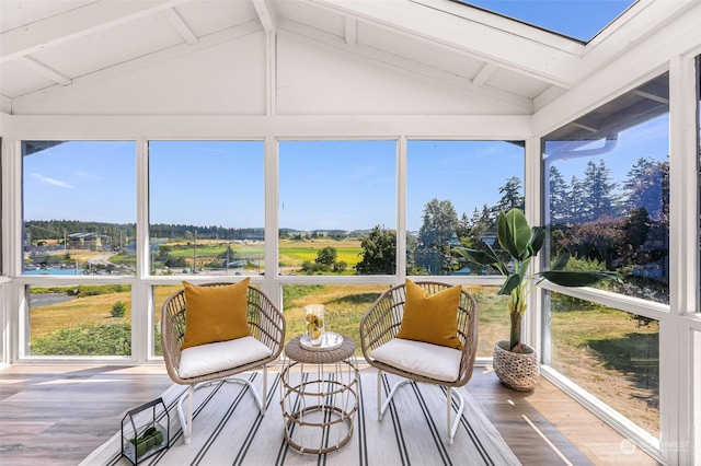 sunroom / solarium featuring lofted ceiling with beams