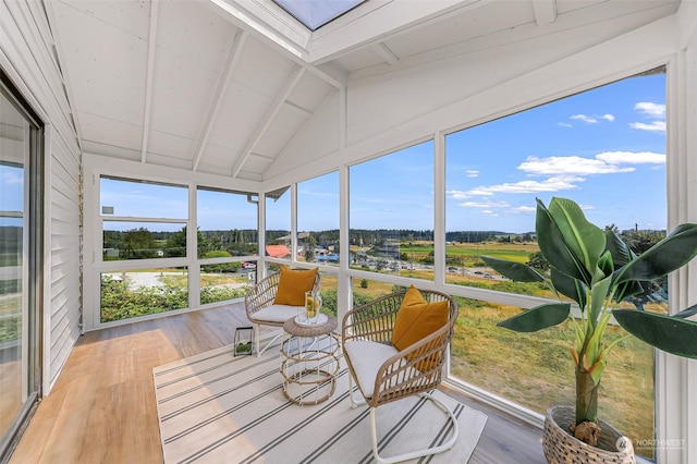 sunroom featuring lofted ceiling with beams