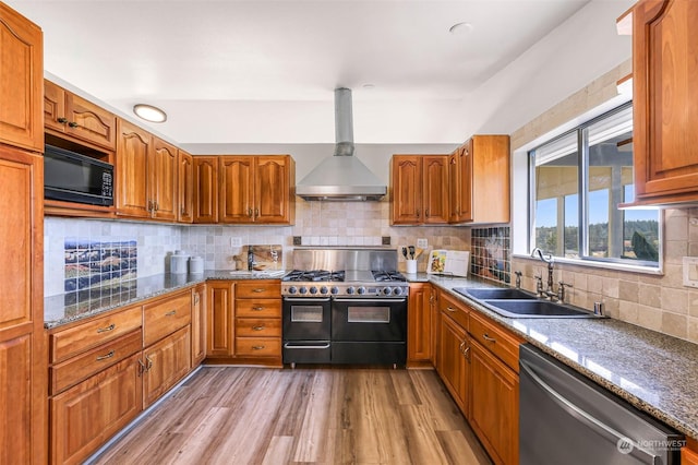 kitchen featuring hardwood / wood-style floors, sink, tasteful backsplash, wall chimney range hood, and black appliances