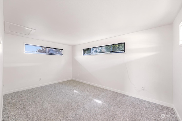 basement featuring baseboards, a wealth of natural light, and carpet flooring