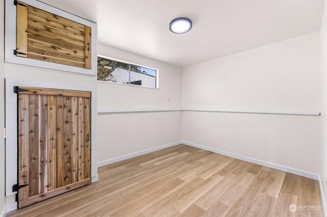 empty room with light hardwood / wood-style floors