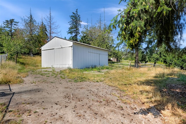 view of pole building featuring fence