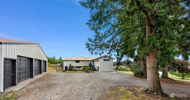 view of front of home with an outdoor structure and a garage