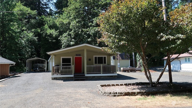 view of front of home with a carport and covered porch