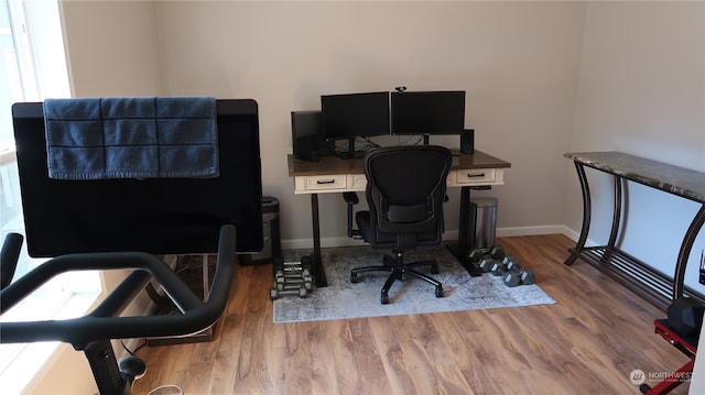 home office with light hardwood / wood-style floors