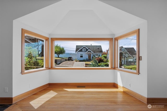 interior space with vaulted ceiling and light hardwood / wood-style floors