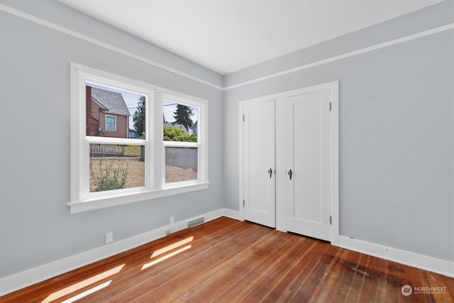 unfurnished bedroom with wood-type flooring