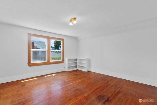 unfurnished room featuring hardwood / wood-style flooring