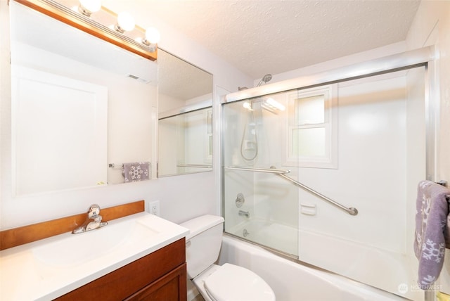 full bathroom with vanity, toilet, enclosed tub / shower combo, and a textured ceiling