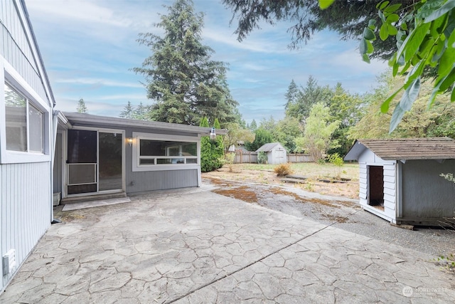 view of patio / terrace featuring a storage shed