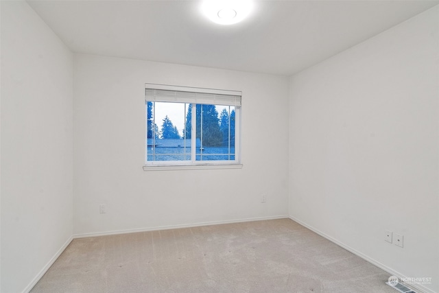 unfurnished room with light carpet