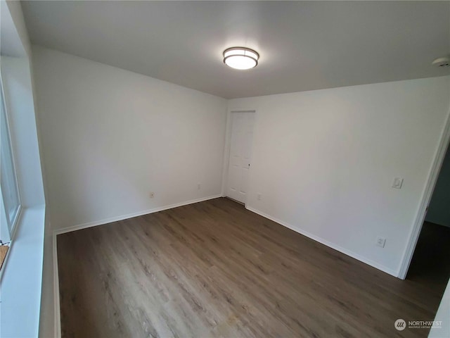 spare room featuring dark hardwood / wood-style floors