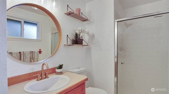 bathroom with walk in shower, toilet, and vanity