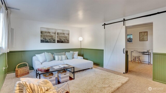 carpeted living room featuring a barn door