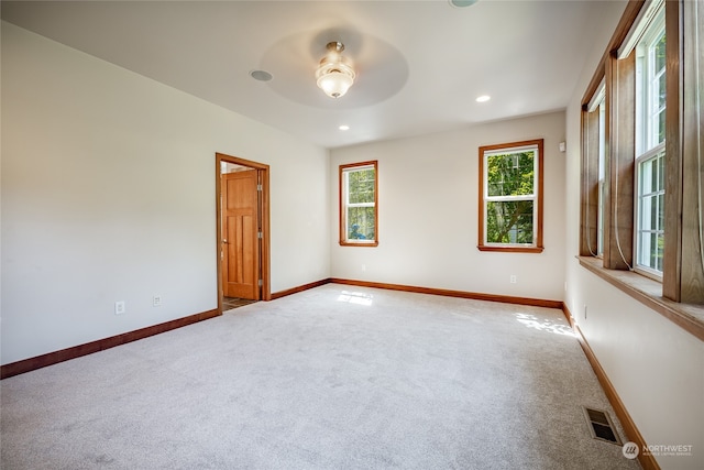 carpeted empty room featuring ceiling fan