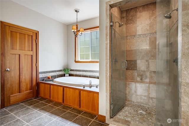 bathroom featuring tile patterned floors, plus walk in shower, and an inviting chandelier