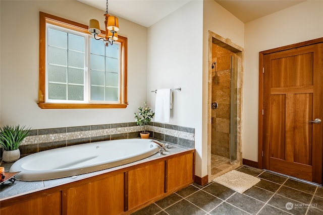 bathroom with tile patterned floors, an inviting chandelier, and independent shower and bath