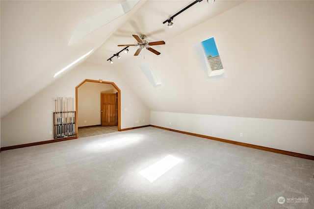 additional living space featuring lofted ceiling and light colored carpet