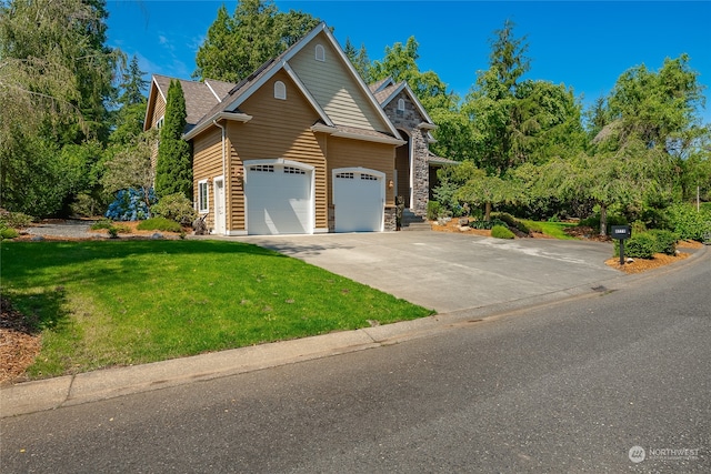 view of front of home with a front yard and a garage