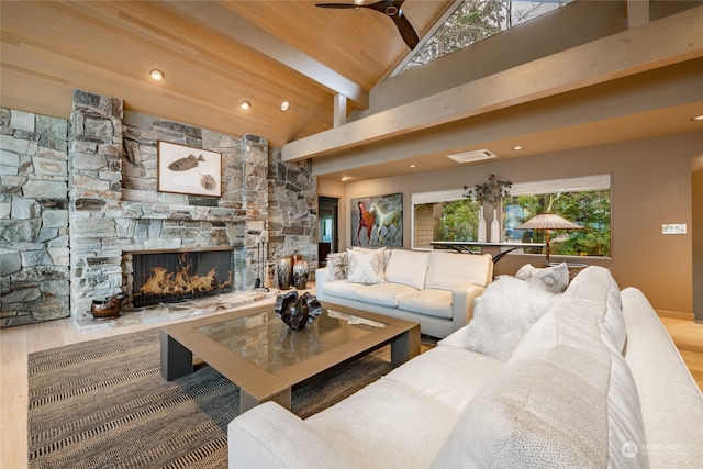 living room with vaulted ceiling with beams, wood ceiling, ceiling fan, a fireplace, and wood-type flooring