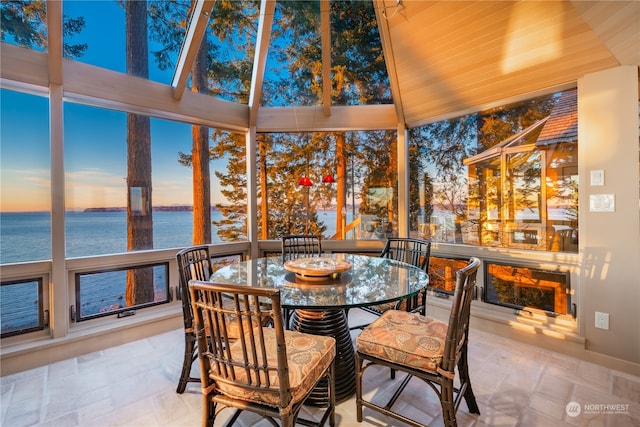 sunroom featuring a water view and wood ceiling