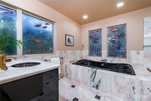 bathroom featuring sink, tile walls, and tiled bath