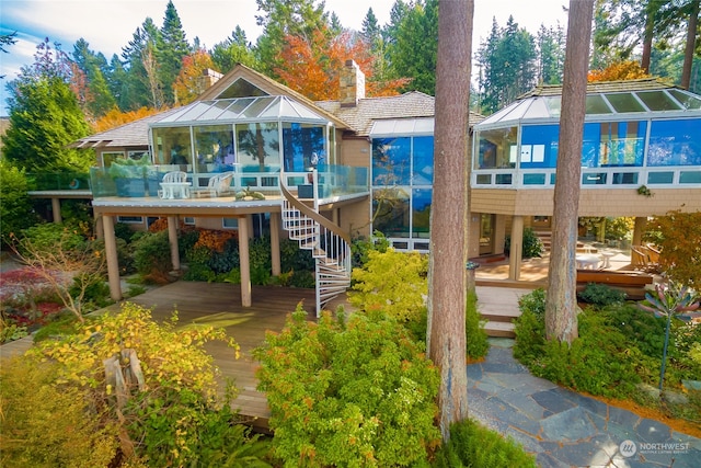 rear view of house featuring a deck