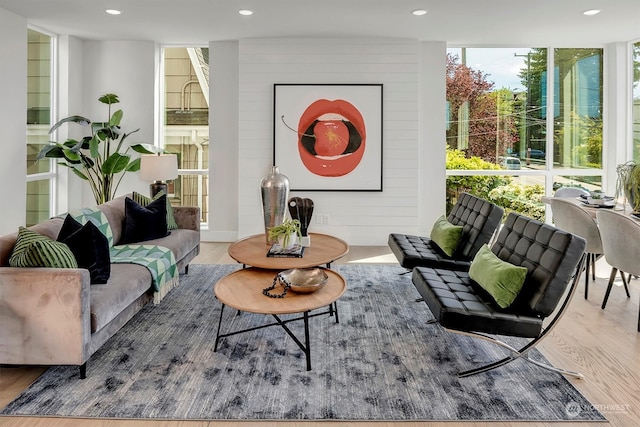 living room featuring expansive windows and hardwood / wood-style flooring