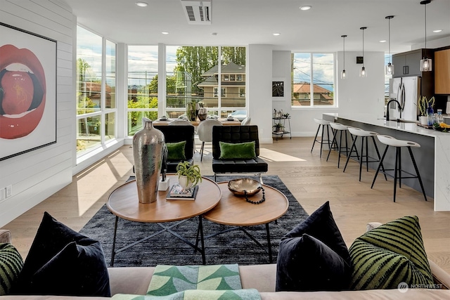 living room featuring light hardwood / wood-style flooring and expansive windows