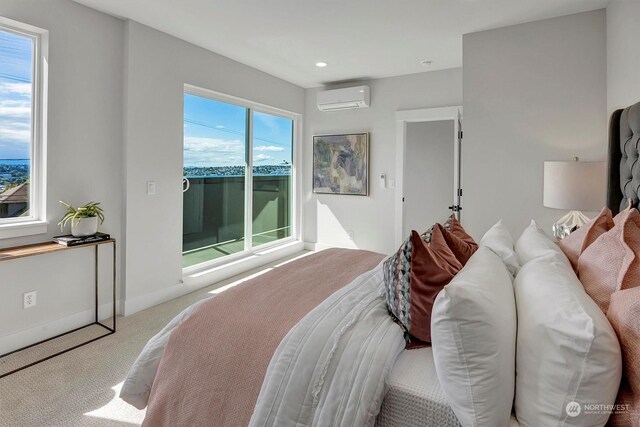 bedroom featuring a wall mounted air conditioner, a water view, and carpet flooring