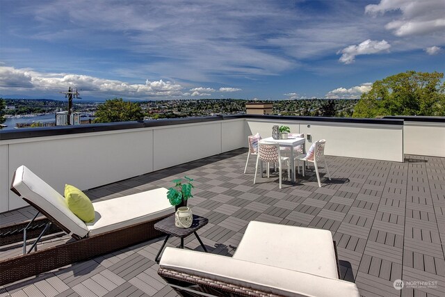 view of patio with a balcony and a water view