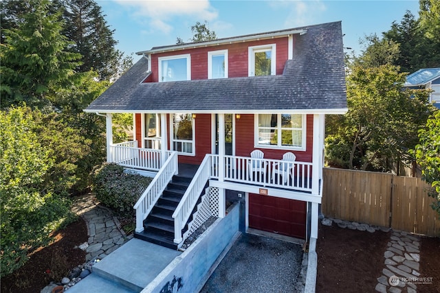 view of front of home featuring a porch and a garage